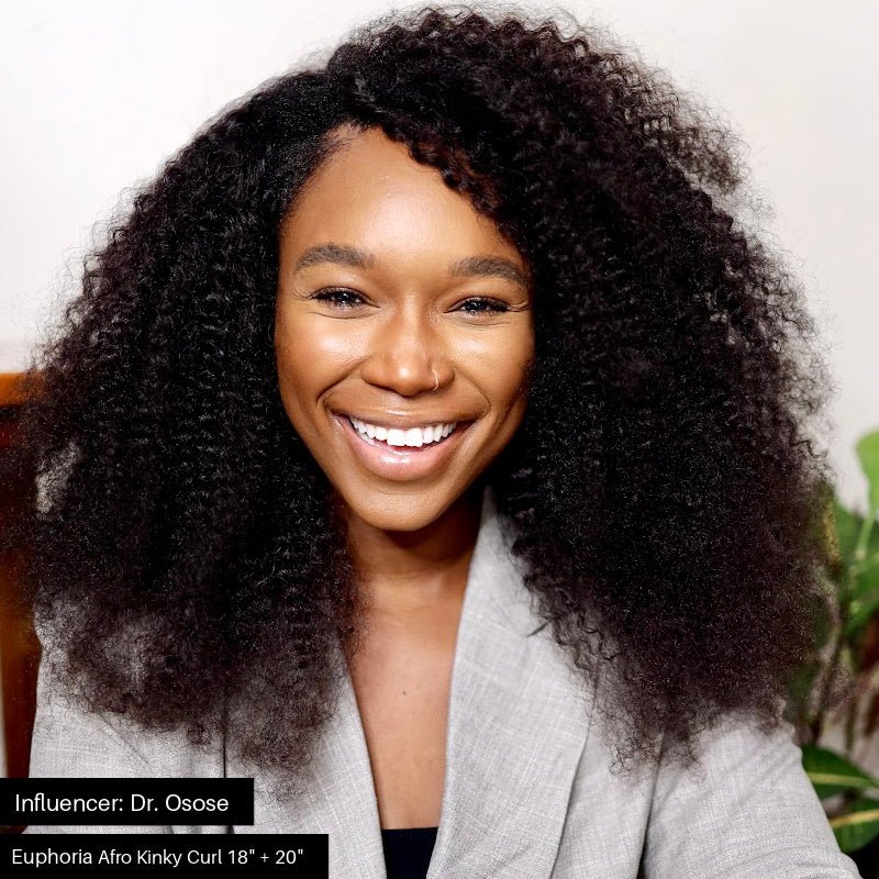 African American Woman Doctor smiling while embracing her afro kinky curly hair extensions by SL Raw Virgin Hair . Hair influencer