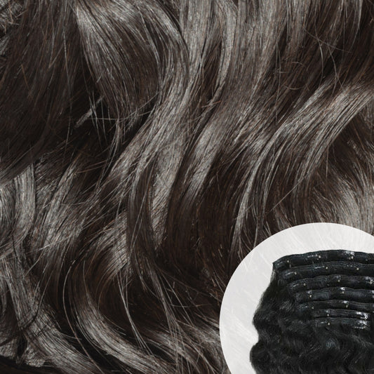 Close-up of Raw Indian curly clip-in hair extensions with a small comb inset. SL Raw Virgin Hair