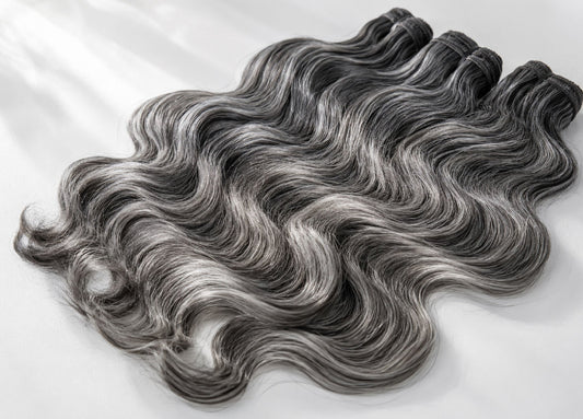 Gray salt-and-pepper human hair extension bundles in a natural loose wave texture with silver and charcoal dimension