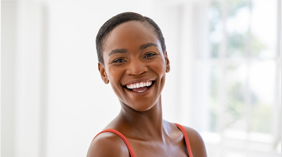 Woman smiling showcasing her oval face shape 