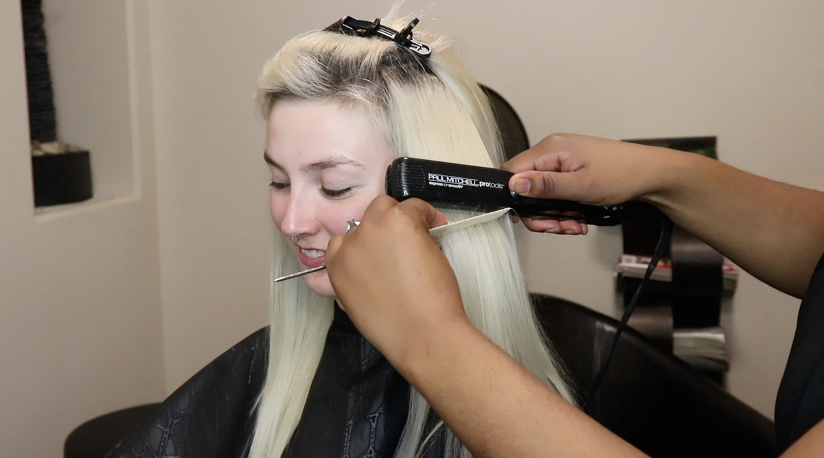 Woman showing how to Hair texture and blending extensions