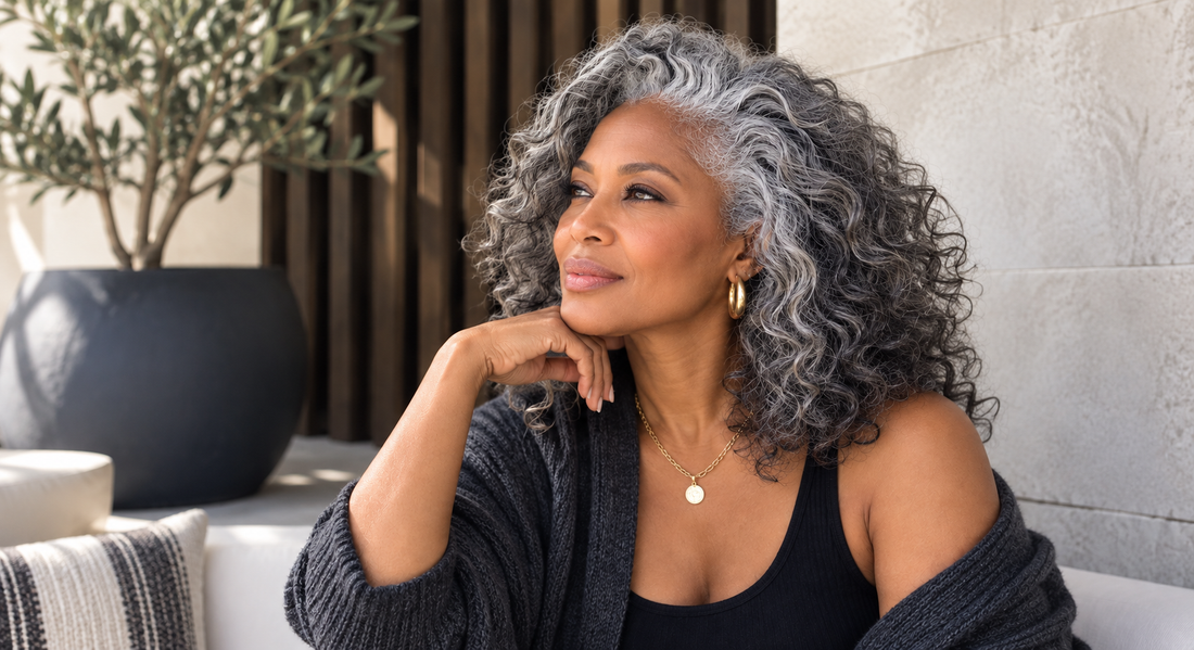 Woman wearing naturally dimensional salt and pepper gray curly hair