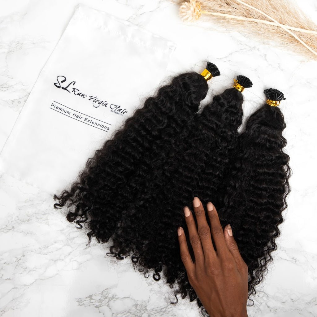 A woman hand touching textured human hair micro-link hair extensions by SL Raw Virgin Hair 