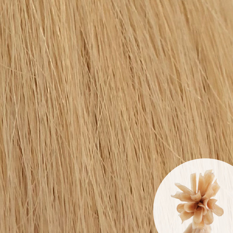 Close-up of soft ash blonde straight hair extensions with a small circular inset showing the K-Tip bundle attachment tip.