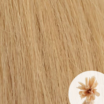 Close-up of soft ash blonde straight hair extensions with a small circular inset showing the K-Tip bundle attachment tip.