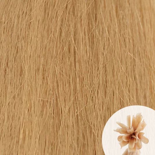 Close-up of light golden blonde straight hair extensions with a small circular inset showing the K-Tip bundle attachment tip.
