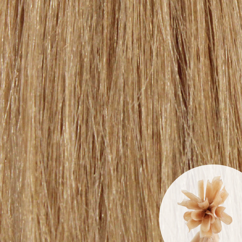Close-up of warm light brown straight hair extensions with a small circular inset showing the K-Tip bundle attachment tip.