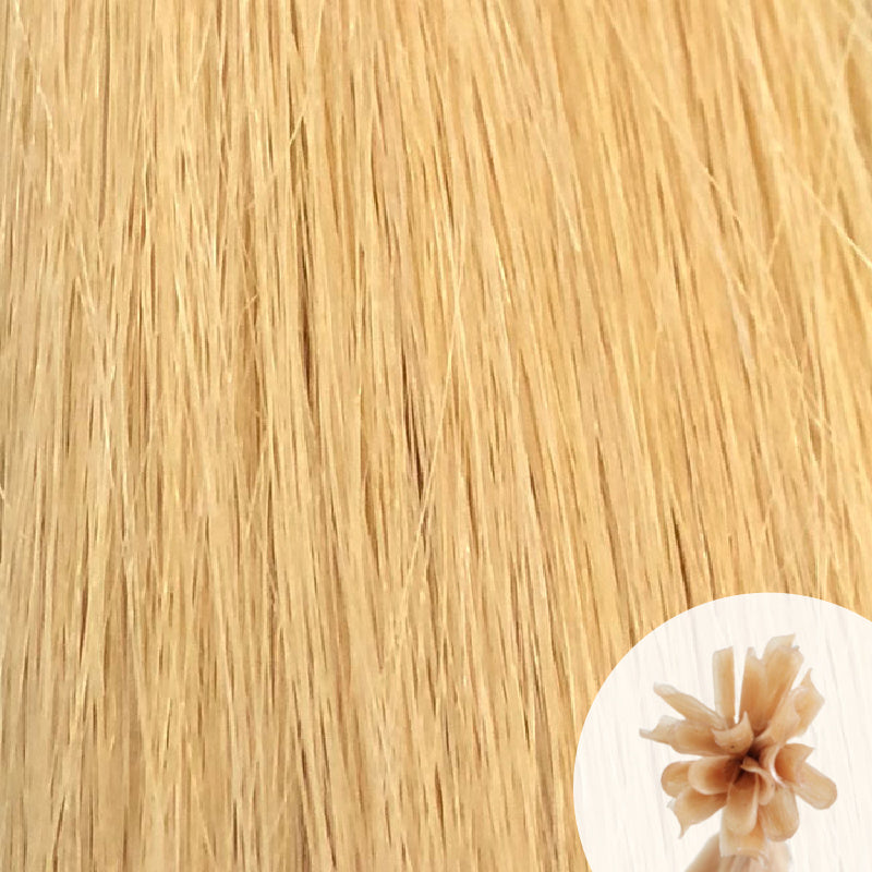 Close-up of light golden blonde 'Honey' straight hair extensions with a small circular inset showing the K-Tip bundle attachment tip.