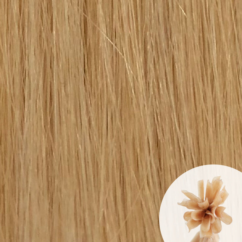 Close-up of yellow blonde straight hair extensions with a small circular inset showing the K-Tip bundle attachment tip.