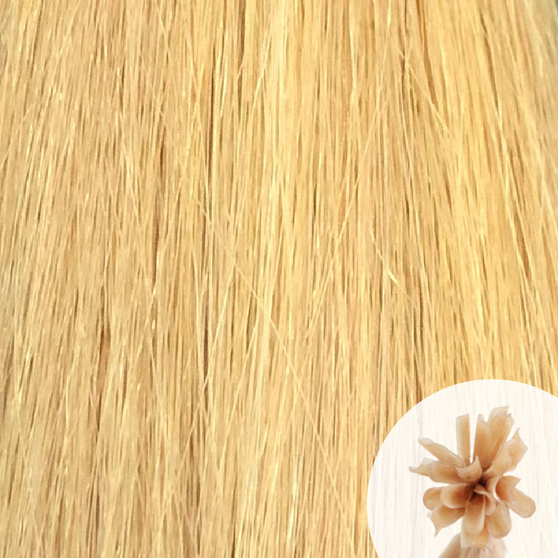 Close-up of platinum ash straight hair extensions with a small circular inset showing the K-Tip bundle attachment tip.