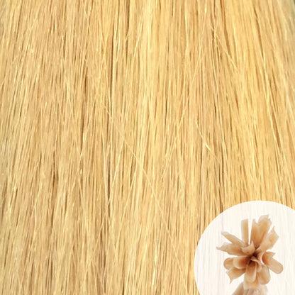 Close-up of platinum ash straight hair extensions with a small circular inset showing the K-Tip bundle attachment tip.