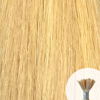 Light golden blonde seamless I-tip hair extensions with a circular inset showing an up-close bundle of the i-tip hair strands on a white background.