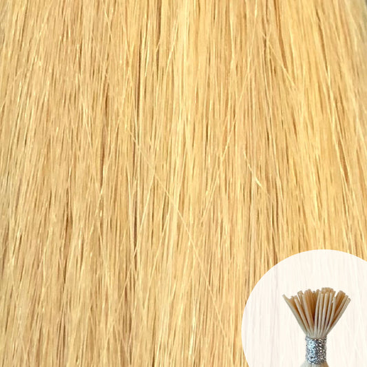 Light golden blonde seamless I-tip hair extensions with a circular inset showing an up-close bundle of the i-tip hair strands on a white background.