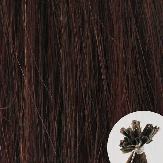 Close-up of dark brown reddish straight hair extensions with a small circular inset showing the K-Tip bundle attachment tip.