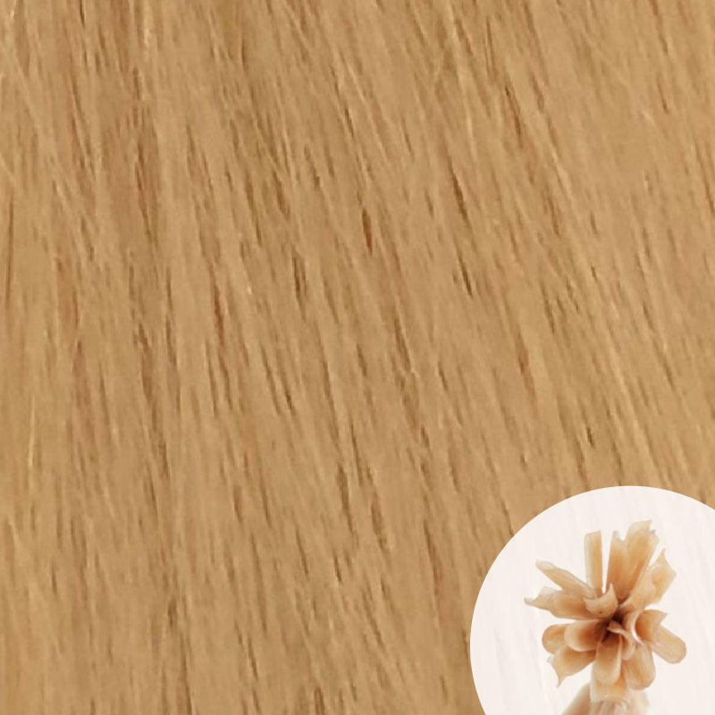 Close-up of light yellow blonde straight hair extensions with a small circular inset showing the K-Tip bundle attachment tip.