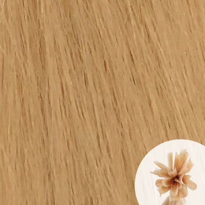 Close-up of light yellow blonde straight hair extensions with a small circular inset showing the K-Tip bundle attachment tip.