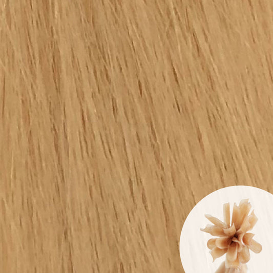 Close-up of light yellow blonde straight hair extensions with a small circular inset showing the K-Tip bundle attachment tip.