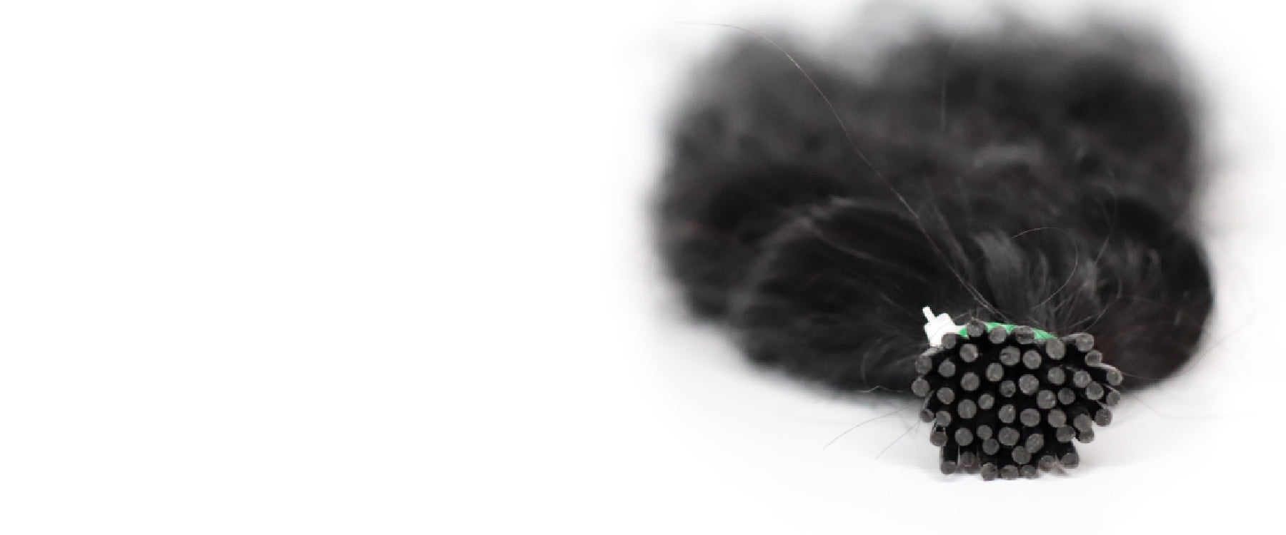 Close-up of premium I-tip hair extensions featuring durable keratin tips, designed for professional salon installations.