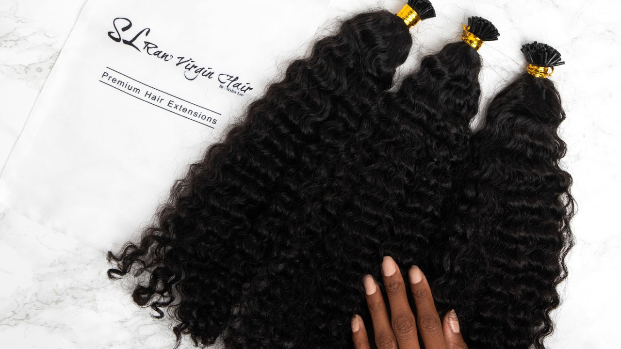 Luxury microlink hair extensions - Premium I-tip extensions for seamless installation. Black hair extensions with a hand holding them with SL Raw Virgin Hair Branding