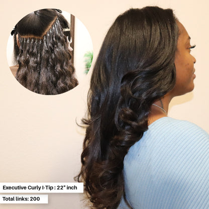 Woman wearing Executive Curly I-Tips bundle pack in 22-inch . Installed as Micro-link Hair extensions on relaxed textured hair. The Curly I-tips are loose in curl and displays a natural black with dark brown hues. Hair was heat styled to have tousled body curls. Only available at SL Raw Virgin Hair