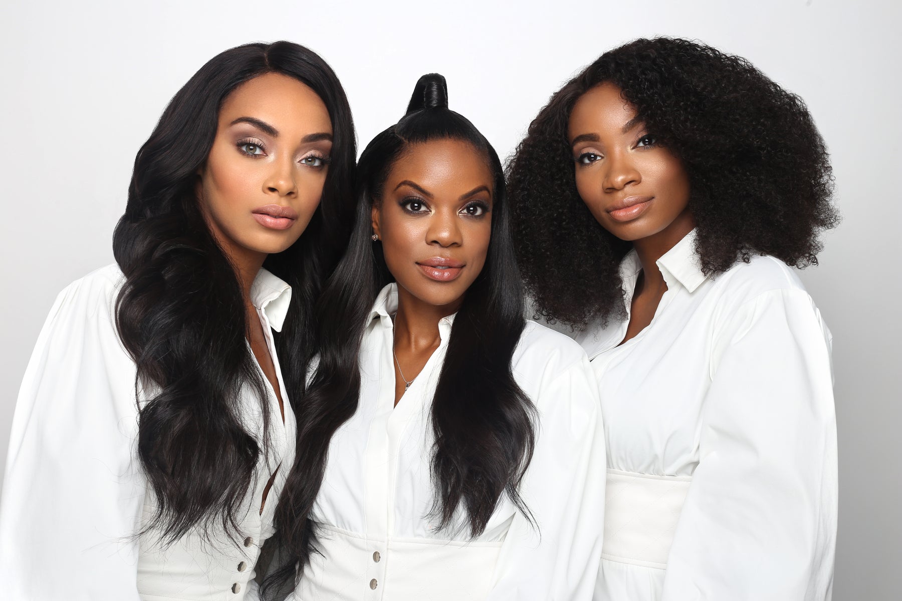 Three women wearing SL Raw Virgin Hair extensions in natural textures — straight, wavy, and curly — showcasing realistic, luxury raw human hair.