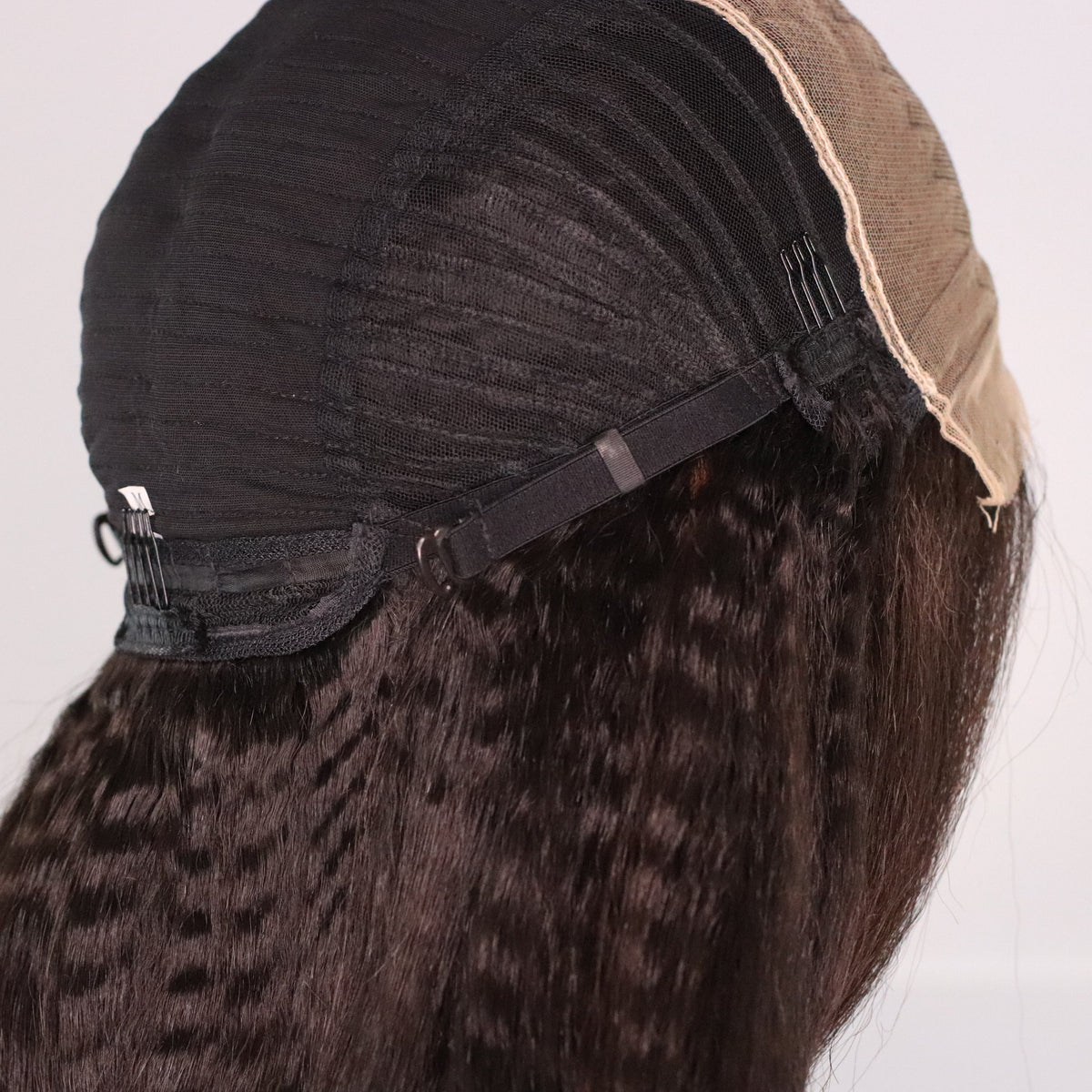 Back interior of Kinky Straight Fit 'N' Go Wig showing adjustable strap, rear comb and ventilated cap