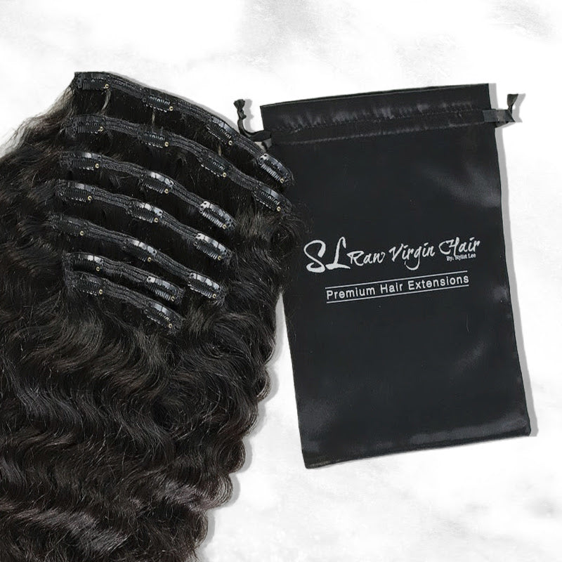 Beautifully photographed SL Raw Majesty Clip-in set next to company branded satin extension bag 