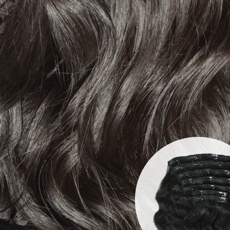 Close-up of Raw Indian curly clip-in hair extensions with a small comb inset. SL Raw Virgin Hair 
