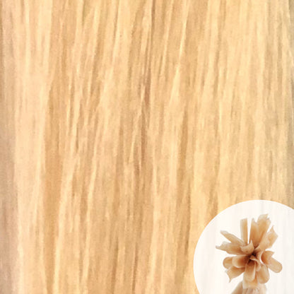 Close-up of alpine blonde straight hair extensions with a small circular inset showing the K-Tip bundle attachment tip.