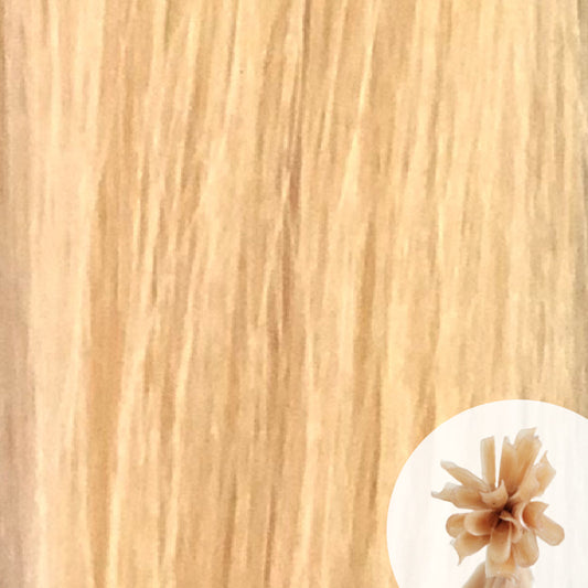 Close-up of alpine blonde straight hair extensions with a small circular inset showing the K-Tip bundle attachment tip.