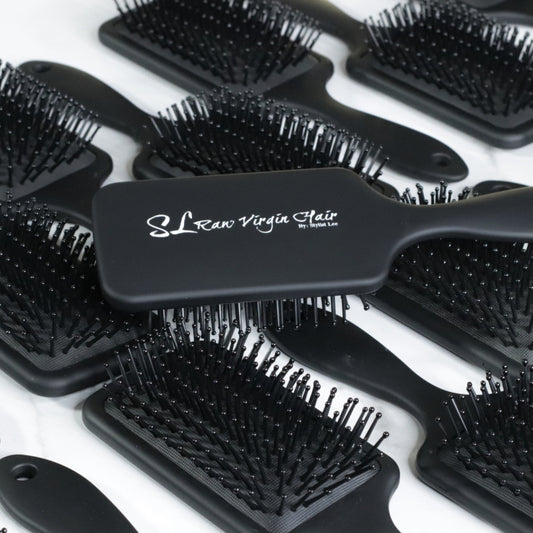Black hairbrushes with 'SL Raw Virgin Hair' branding on a white background