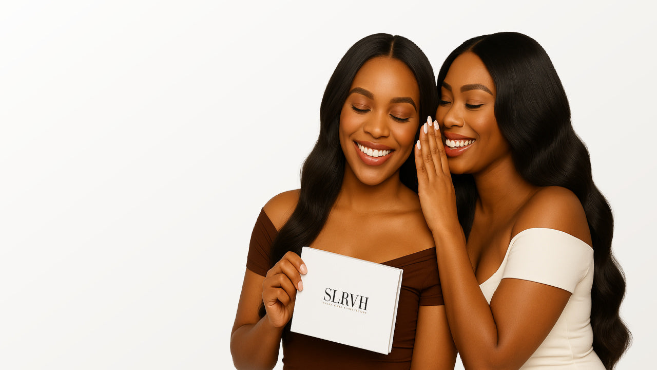 Two women smiling and holding a box with 'SLRVH' on it against a white background