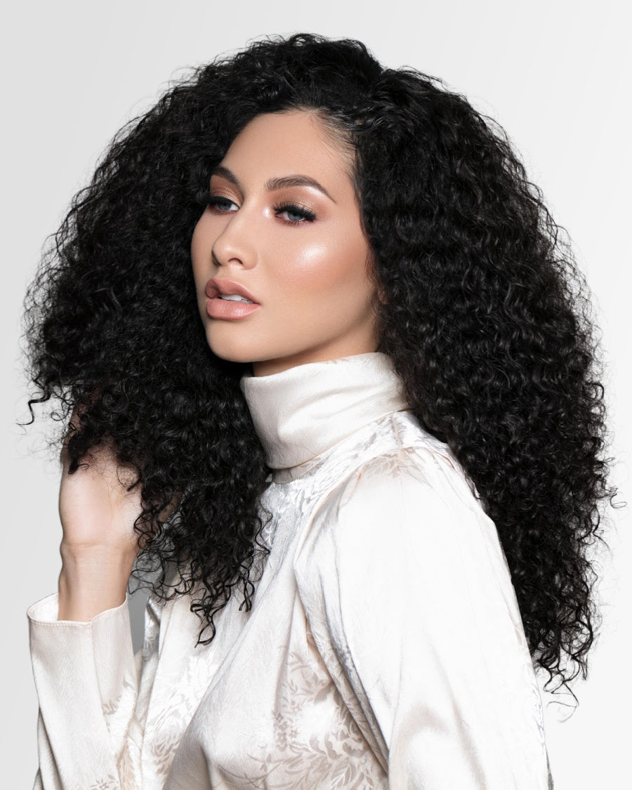 Woman wearing defined curly human hair extensions
