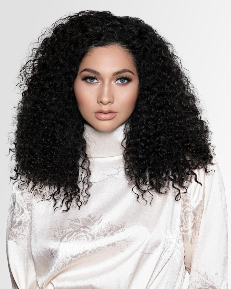 SL Raw Girl Model with voluminous Burmese curly hair wearing a white garment on a light gray background