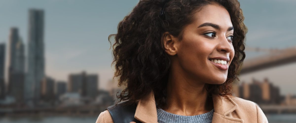 NYC woman overlooking New York City with curly hair extensions 