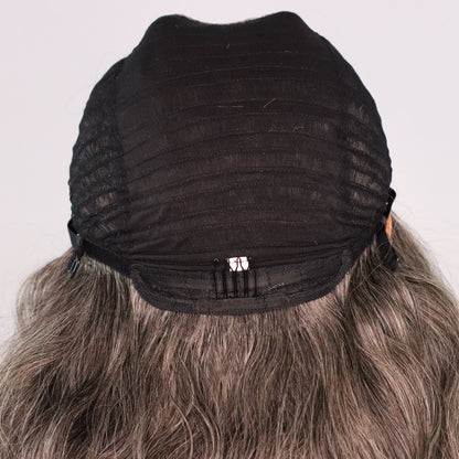 Back interior of natural gray human hair wig showing ventilated cap, rear comb and adjustable construction