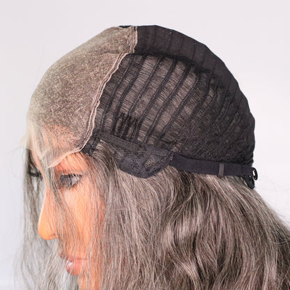 Side interior view of salt-and-pepper human hair wig showing HD lace top, cap construction and adjustable strap
