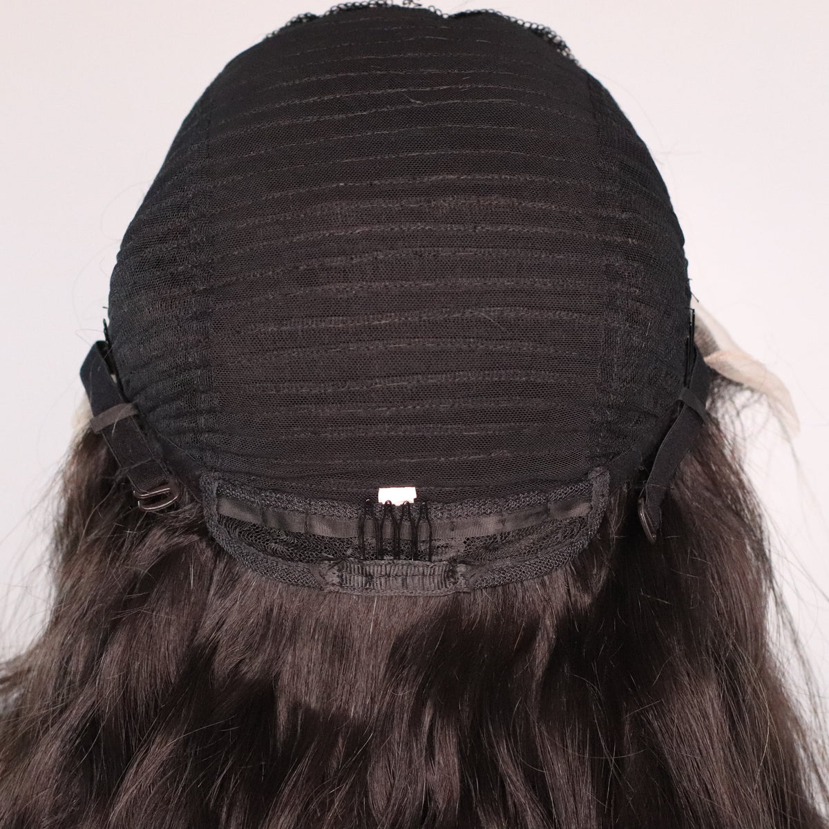 Side view of Natural Wavy human hair wig showing lace front area, cap construction and adjustable strap