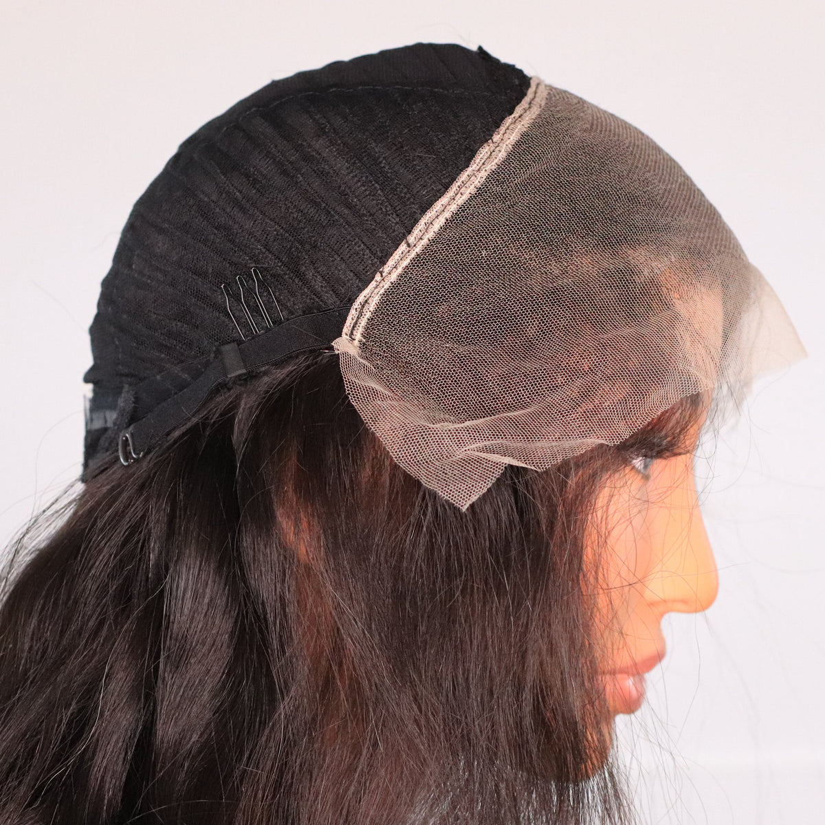 Interior side view of Natural Wavy lace front wig showing HD lace, comb, adjustable strap and ventilated cap