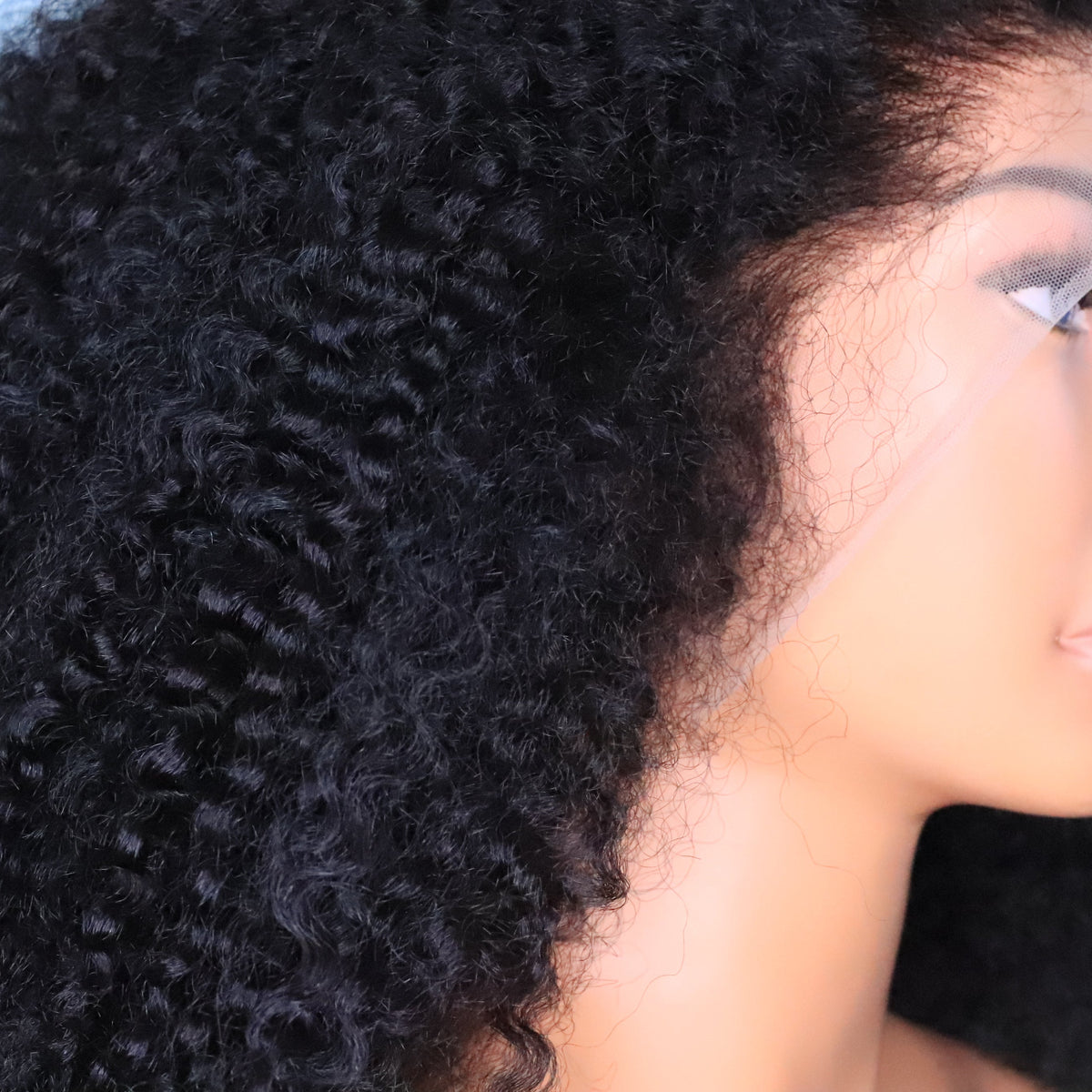 Side view of Soft Kinky Curly 13x6 lace front wig showing curly hair texture and extended lace coverage around the temple