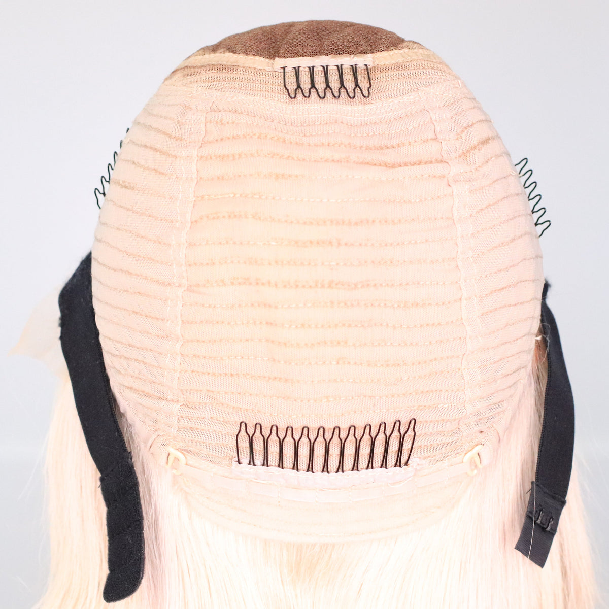 Interior view of Vixen Frost platinum blonde wig showing cap construction, combs, adjustable straps and elastic band